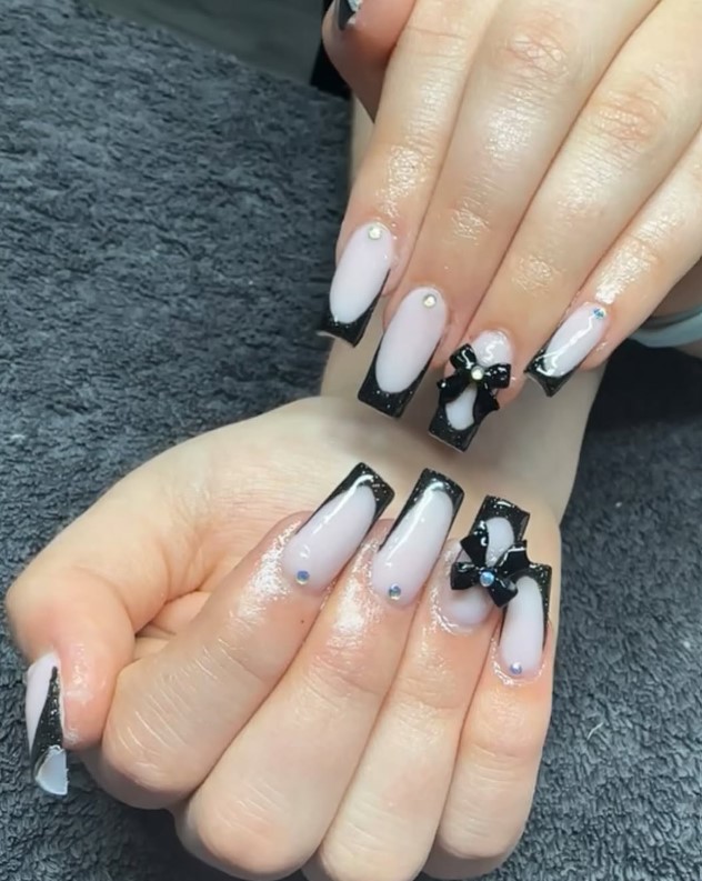 Long black and white nails with bows and gems